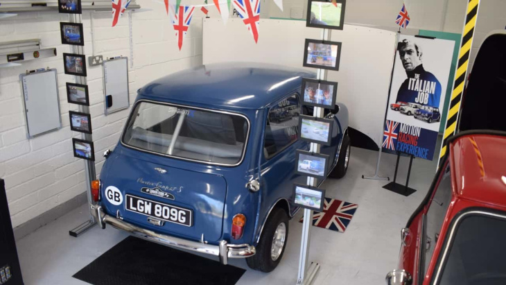 A classic Mini Cooper in a garage.